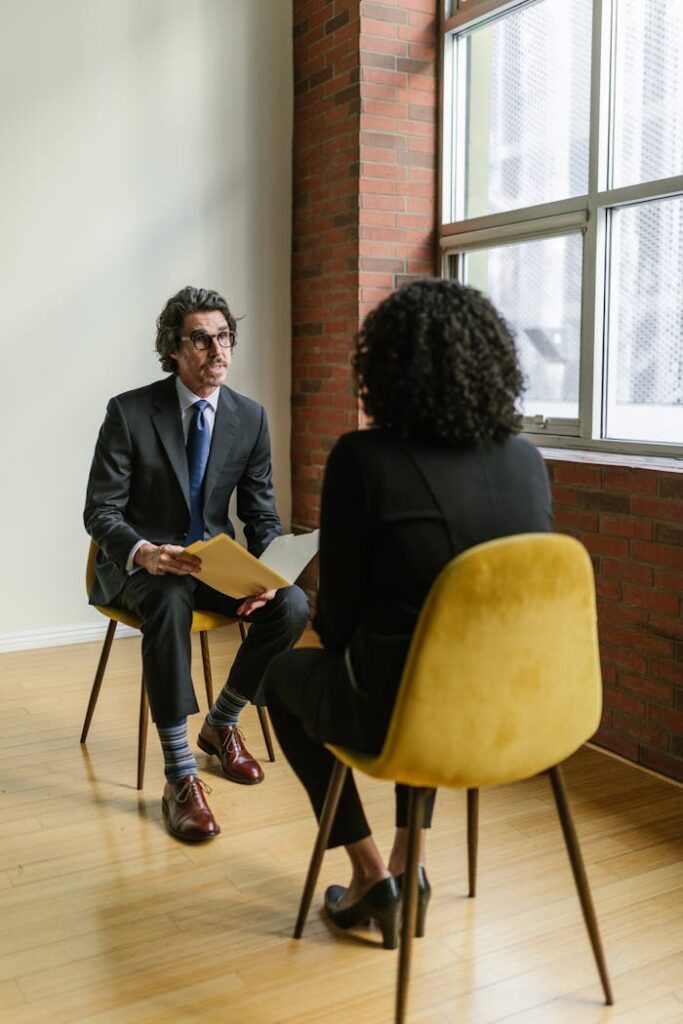 pexels photo 8124241 Two professionals in a modern office setting having a conversation. Ideal business and corporate representation.